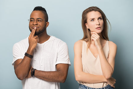 Pensive multiracial millennial man and woman isolated on blue studio background look in di