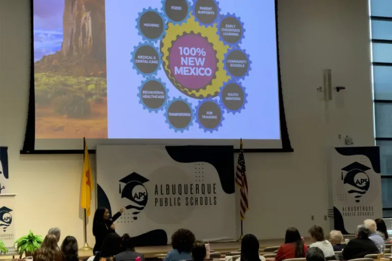 Large screen projection of the ten thriving and surviving services of the 100% New Mexico movement