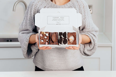 A beautiful gift box of chocolate brownies for easter with all the Easter brownie flavours of creme egg brownie, mini easter egg brownie, chocolate orange brownie, and an Oreo Brownie