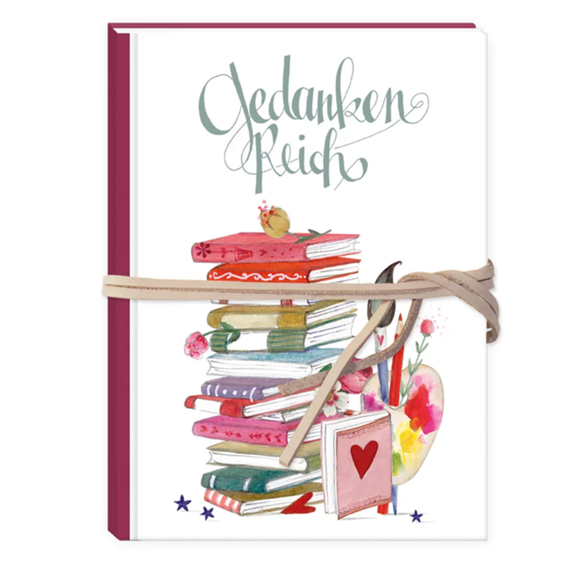 Notizbuch „Gedankenreich“ mit weißem Einband, buntem Bücherstapel, Malutensilien und beigefarbenem Verschlussband.