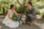 a bride and groom newlywed photos posing with their dog during their first look