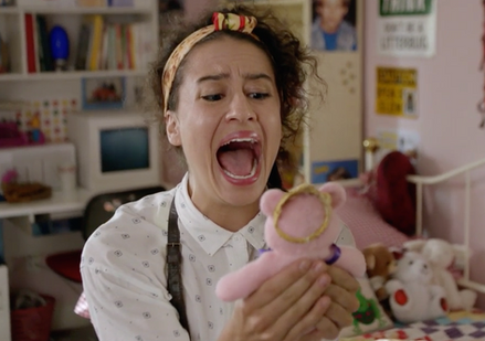 a woman in her bedroom screams while holding a small pink stuffed bear