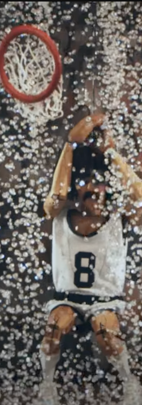 a puppet basketball player cowers under a rain of glass and a falling hoop