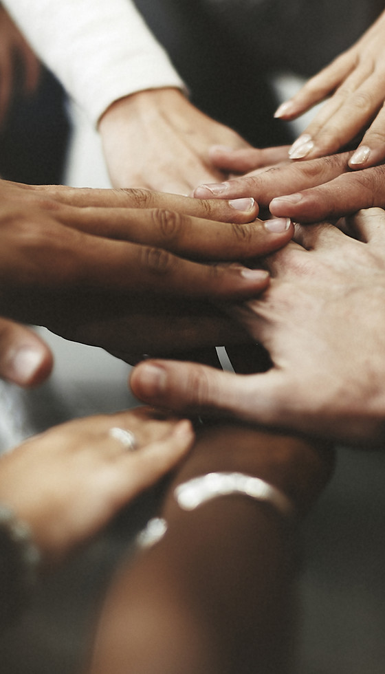 People with joined hands as a team.jpg