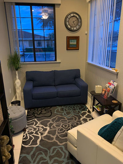 Eye-level view of a calm therapy room with comfortable chairs and soft lighting