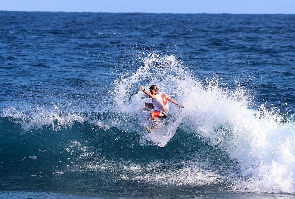 Tucker Demsey skillfully executes a tail slide on a vibrant wave at Middles.