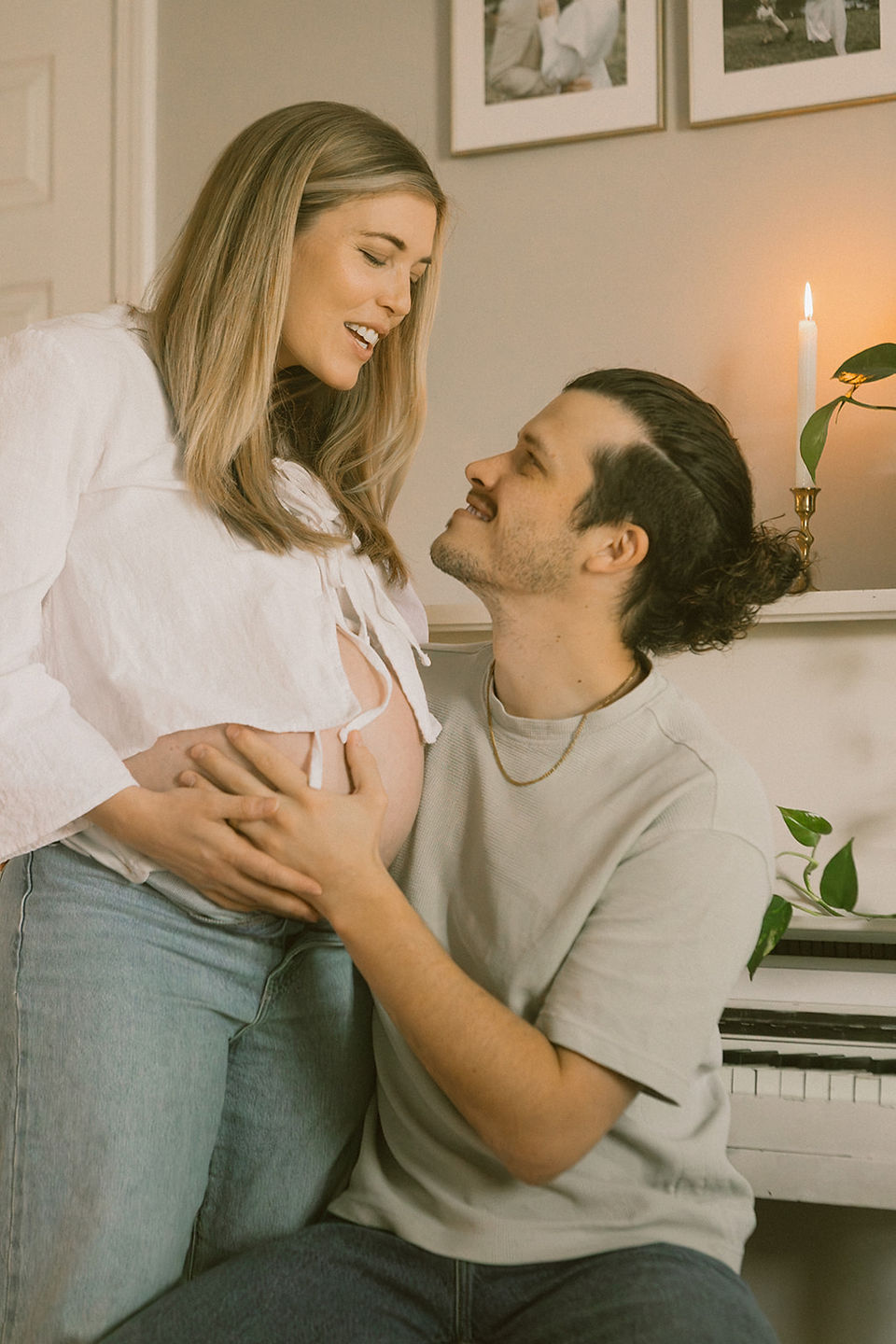 husband smiling at wife and celebrating motherhood photos
