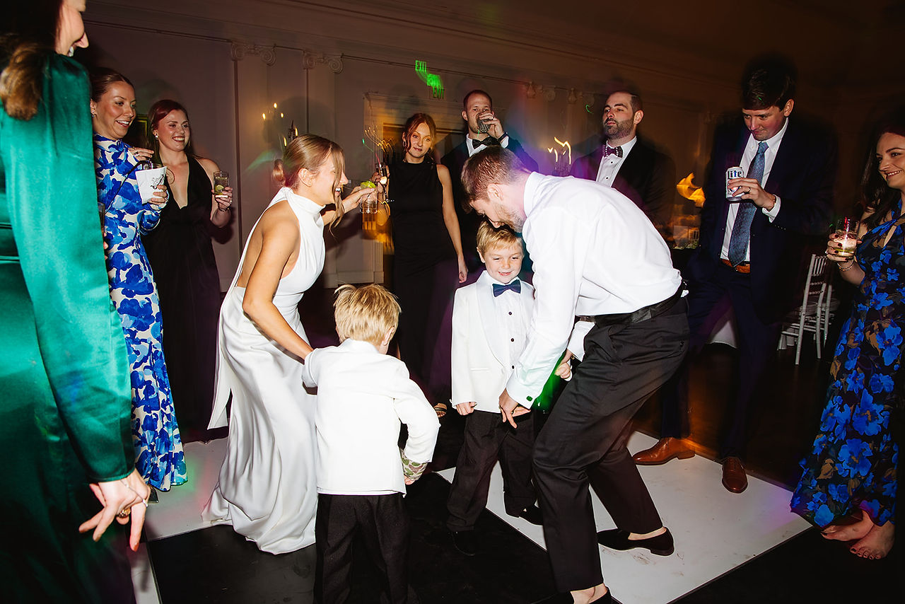 People out on the dance floor having fun and dancing at Idle our Country Club reception