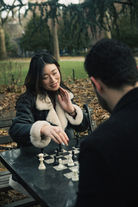 NYC couples photographer, Washington Square Park engagement photography, New York City couple photos, Washington Square Arch engagement photos NYC, winter engagement photography NYC, editorial couples photographer New York, cinematic engagement session NYC, romantic couple photography Washington Square Park, chess table engagement photos NYC, luxury engagement photographer NYC, documentary couples photography New York, playful engagement photos NYC, film wedding photographer NYC, intimate couples session New York City, NYC winter photoshoot couples