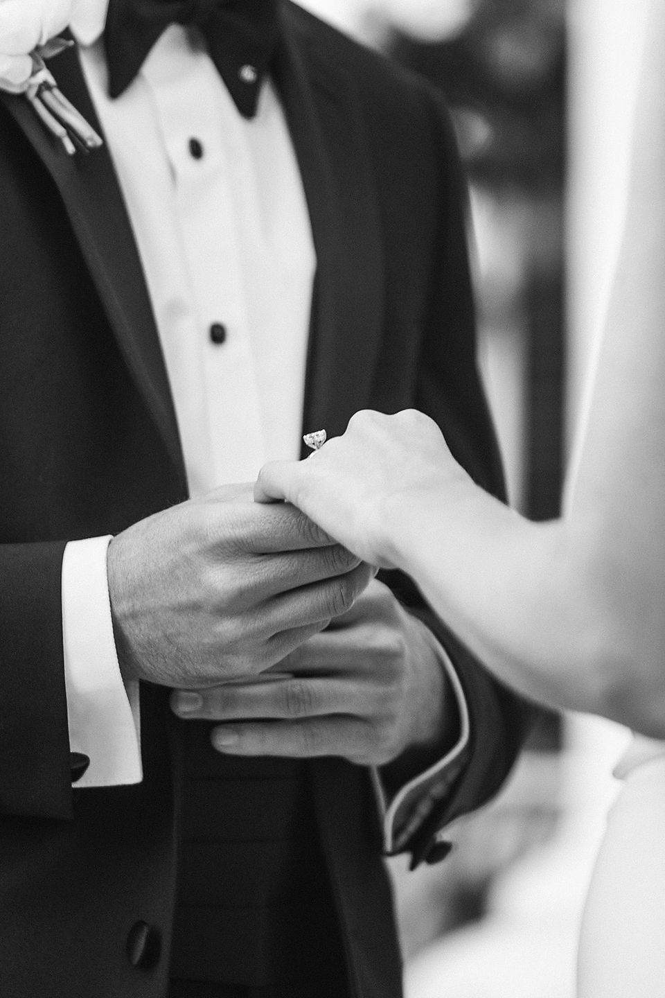 Groom hold brides hand with a beautiful ring on it at 1842 Inn