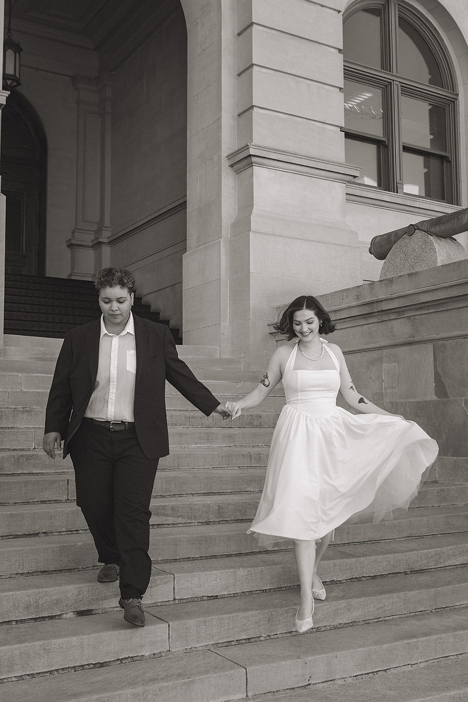 WLW engagement session, Georgia State Capitol, Atlanta, downtown Atlanta engagement session, same-sex couple, two brides, classic architecture, marble staircases, elegant setting, timeless aesthetic, soft natural light, editorial portraits, candid moments, romantic, playful connection, intimate moments, historic Atlanta location, refined backdrop, light-filled interior, outdoor steps, documentary-style photography