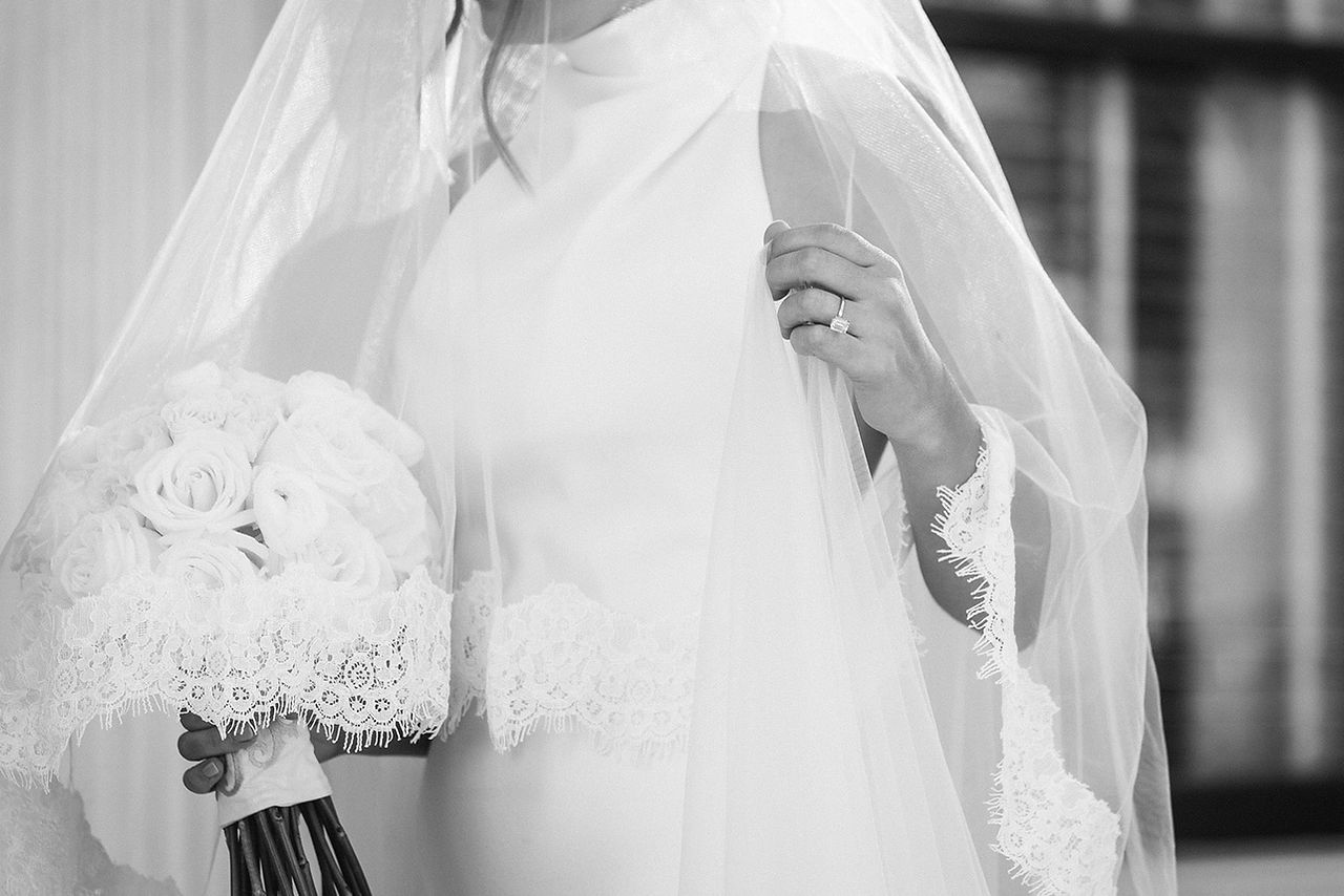 Bride is holds bouquet and poses for a picture at 1842 Inn