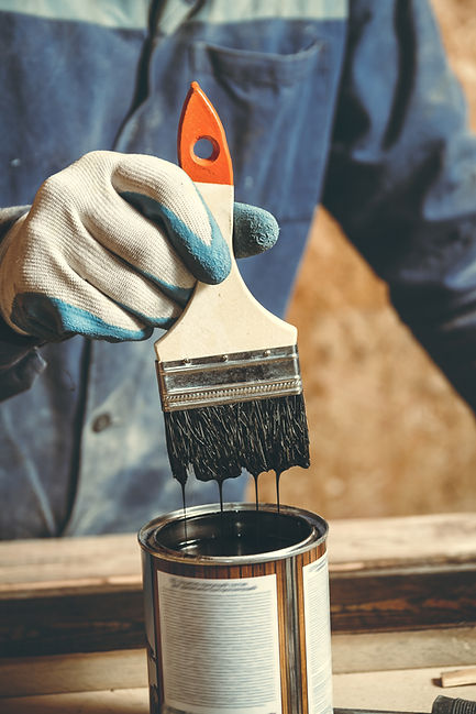 man-paints-handmade-wooden-product-with-paint-workshop (1).jpg