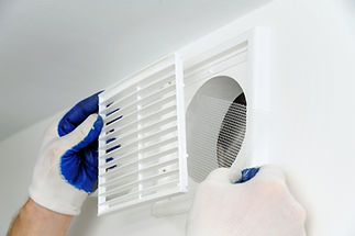 worker-installs-ventilation-grille.jpg