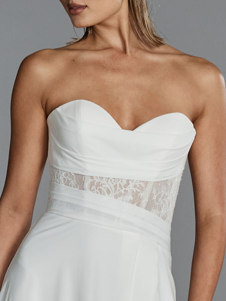 Soft a-line crepe wedding dress with lace cut out bodice panel and leg split. Available with detachable lace jacket.