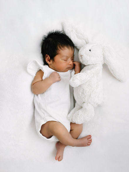 Newborn baby asleep with soft toy at The Greenwich Studio in SE London