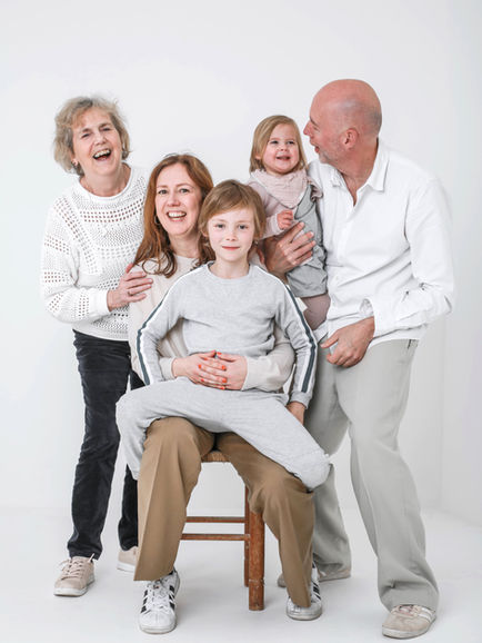 bright and airy white studio backdrop with happy family 