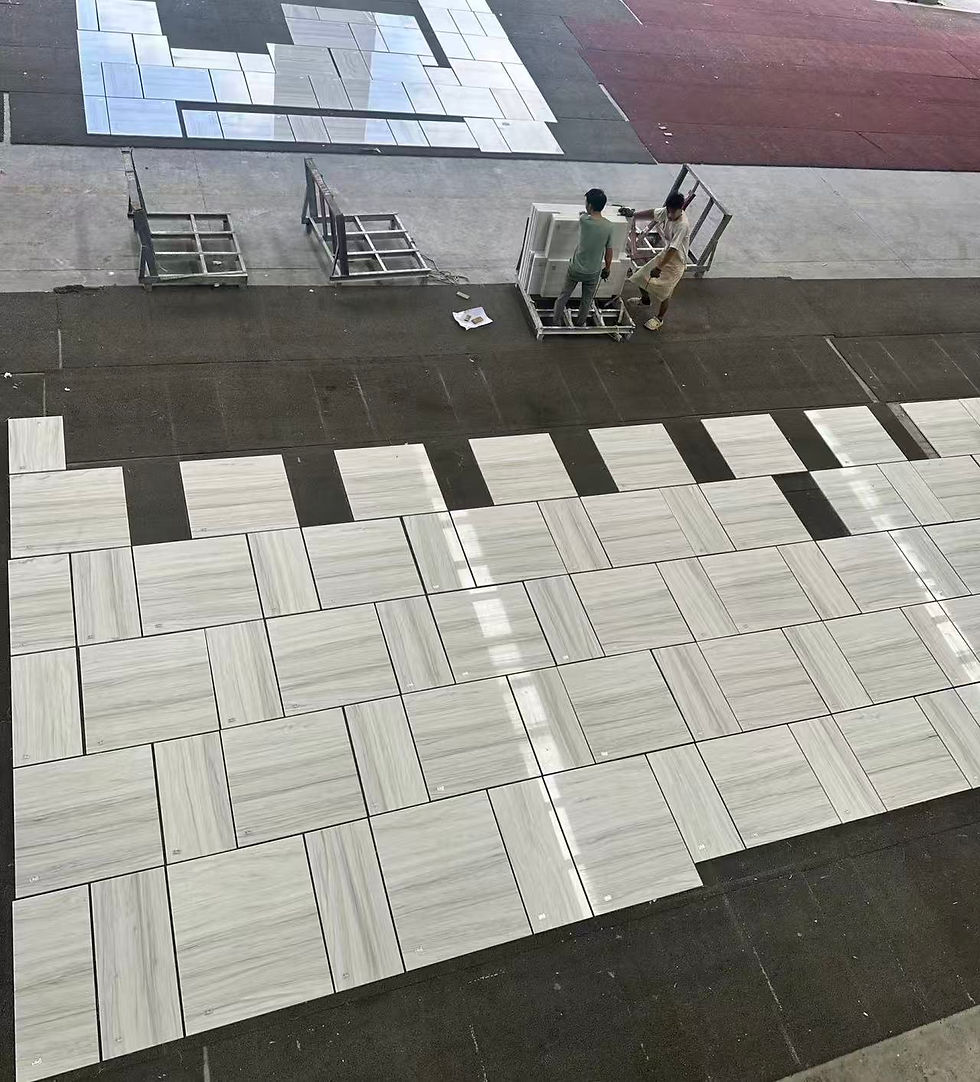 White marble slabs arranged dry-lay according to shop drawings to optimize color consistency and vein alignment after cutting