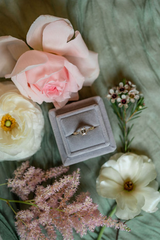 wedding at cathedral oaks wedding flat lay detail shot with blush flowers and wedding ring