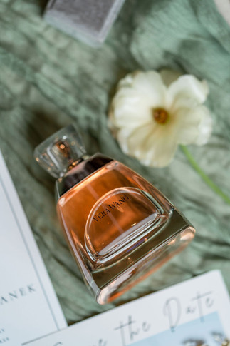 wedding detail flat lay shot with flowers and perfume