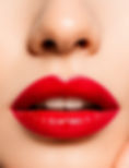 Close-up view of Icon Red Retractable Lip Pencil on a marble surface