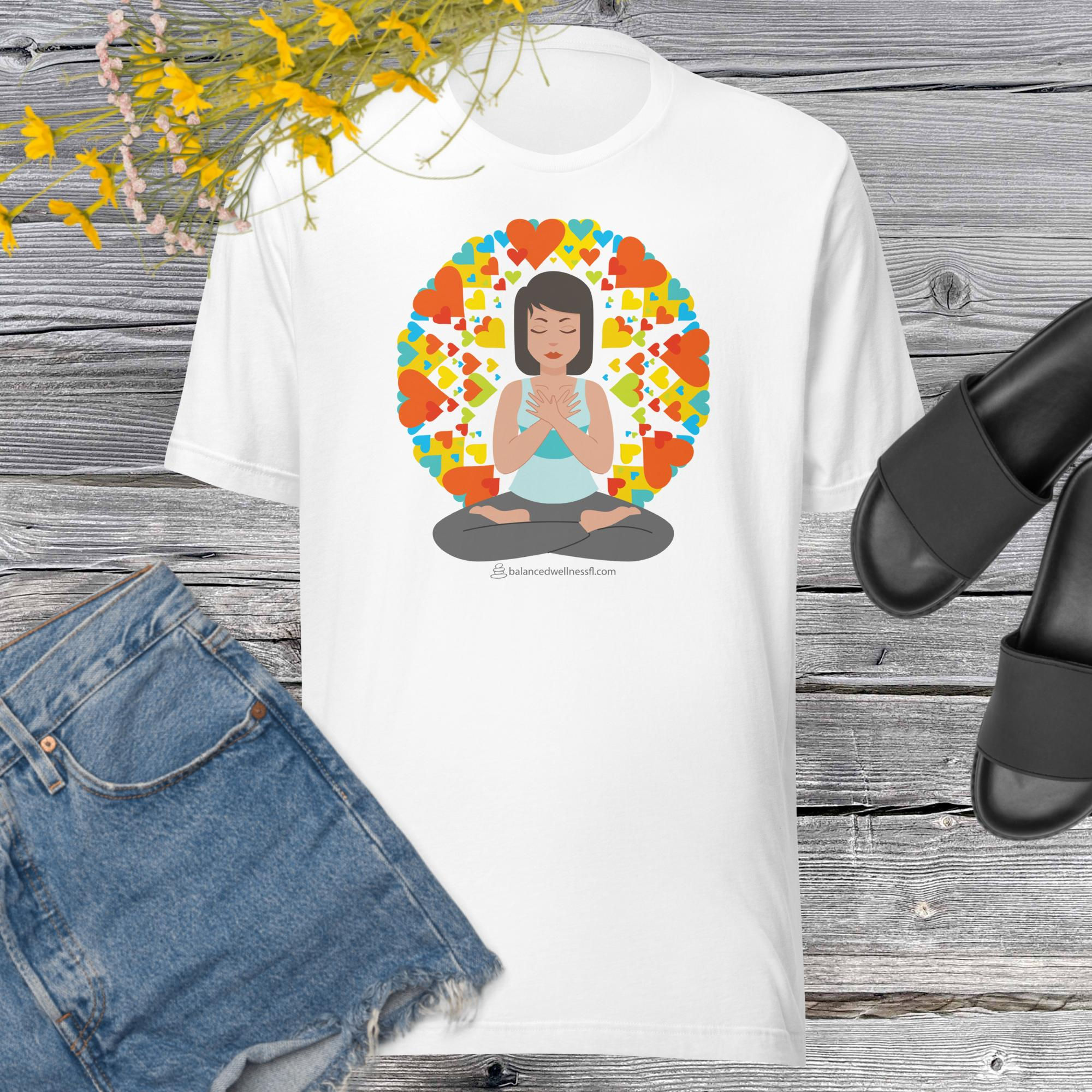 Self Love graphic t-shirt of women in yoga position with both hands crossing the chest surrounded by colorful hearts.
