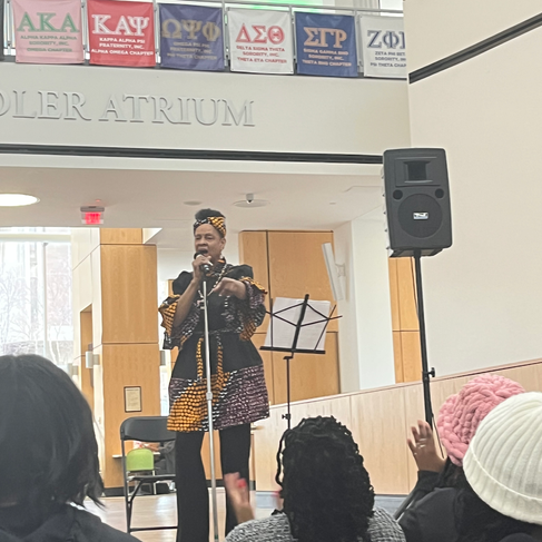 A singer at microphone standing in the CSU Student Center.