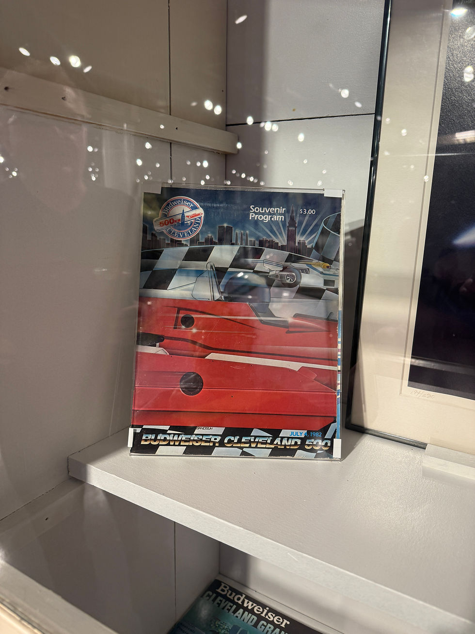Souvenir program featuring a red race car and city skyline on display. Text reads "Budweiser Cleveland 500, July 1982, $3.00."