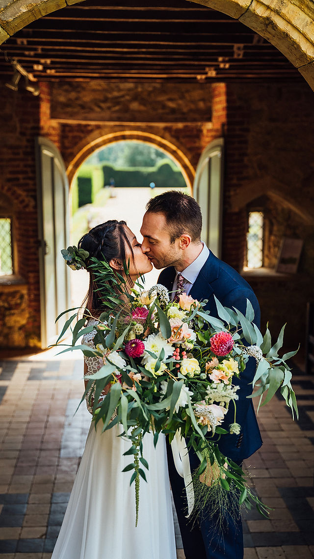 Bride and groom kissing in Penshurst Place and Gardens 