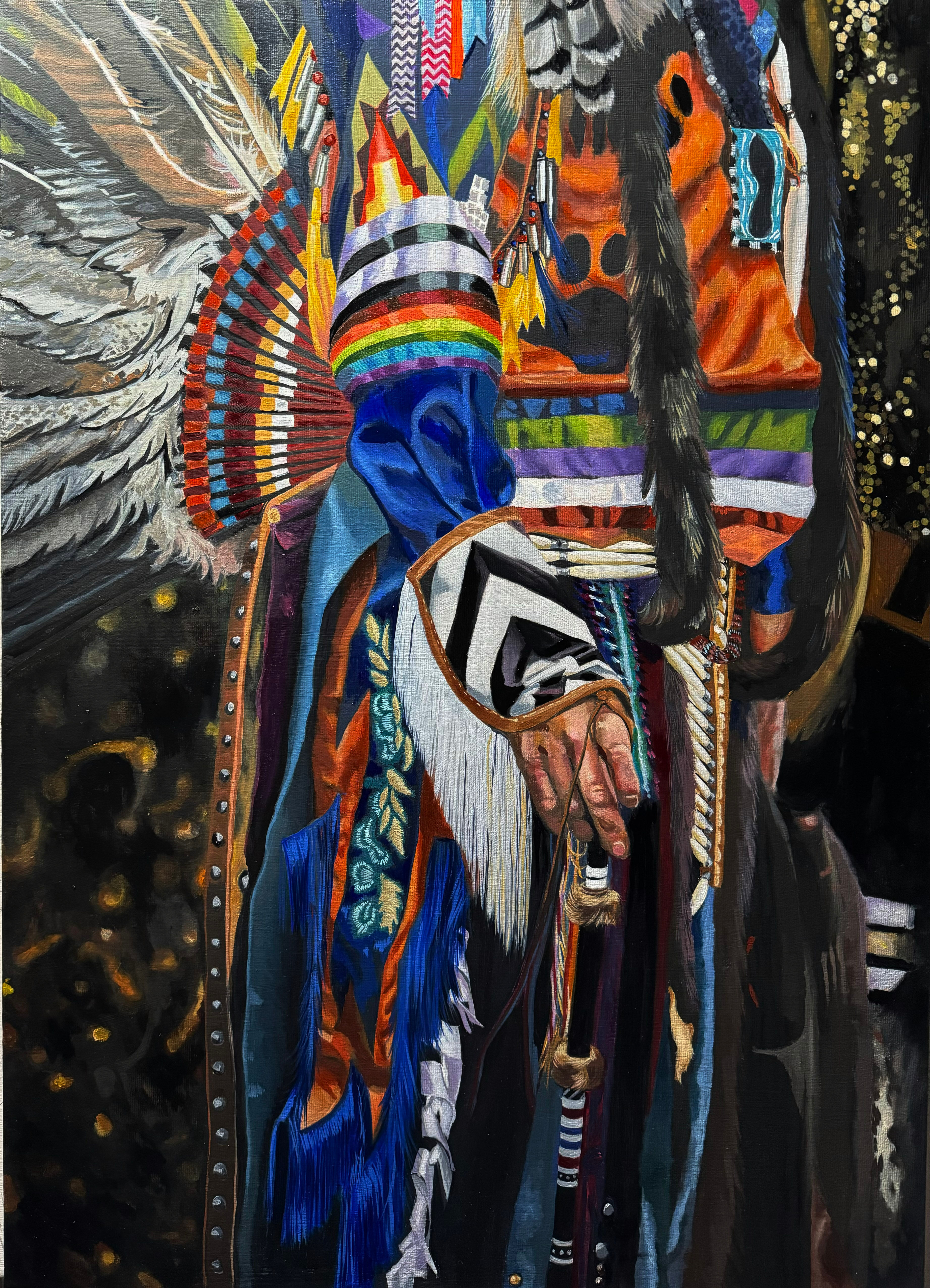 a man's native American ceremonial outfit made of feathers, fur, fringe and satiny fabrics of many colors
