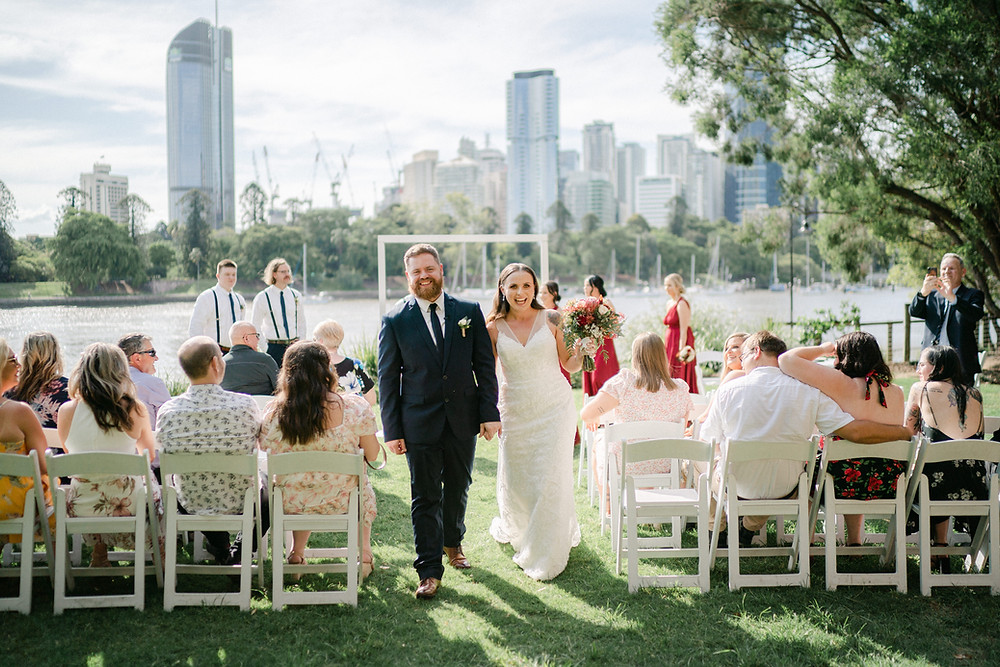 Just married and walking back through their family and friends.