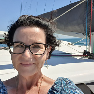 Captain Kerri! Just kidding! Picture of Kerri from Moreton Island Celebrant standing on the bow of the yacht admiring the view