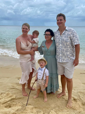 Kerri and a family standing at Tangalooma after a short and sweet wedding ceremony