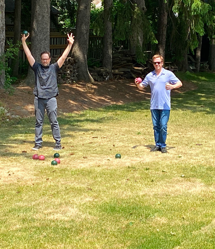 Two men playing lawn bocce