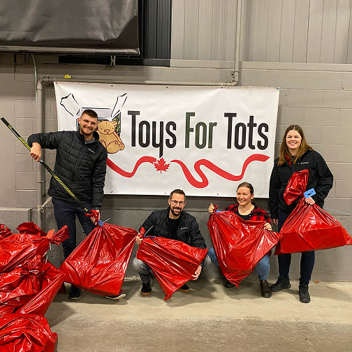 Team volunteering with holiday toy donations