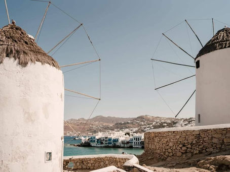 Landscape view of the Mykonos windmills overlooking the sea, representing Greek Island destination weddings.
