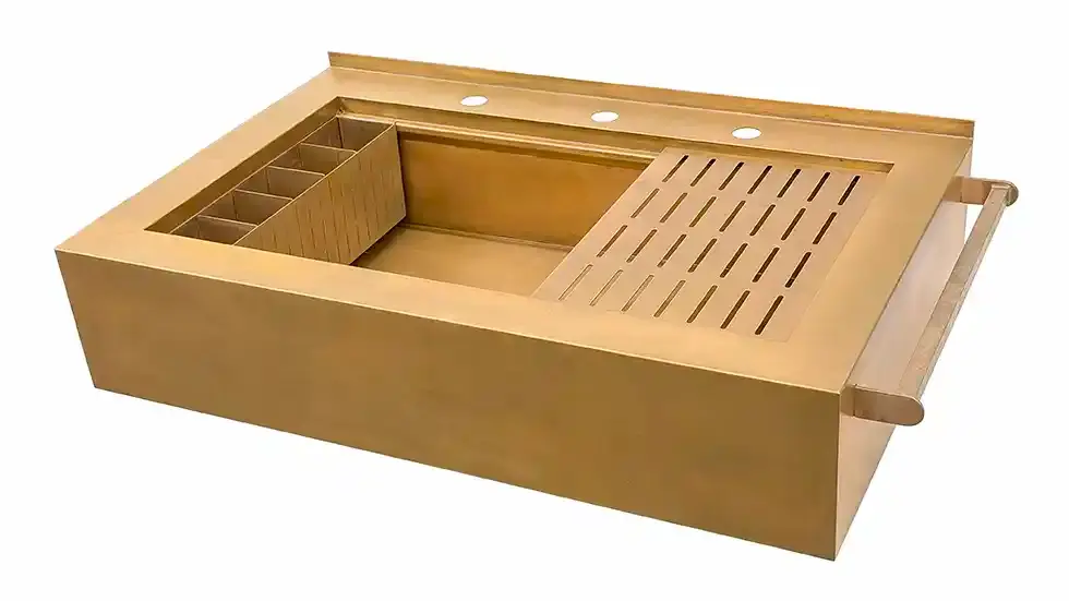 Front view of bronze custom Rachiele® sink with white HDPE cutting board and corner-mounted multi-use grid