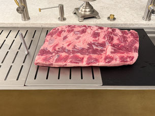 17 pound ribeye laying on a rachiele custom workstation sink
