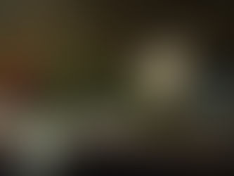 An old clock, wilting rose on dust coverd table.