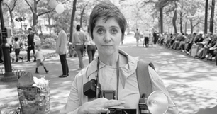 Diane Arbus with a camera in the park.