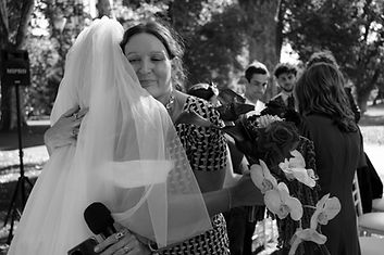 A bride and Celebrant hugging