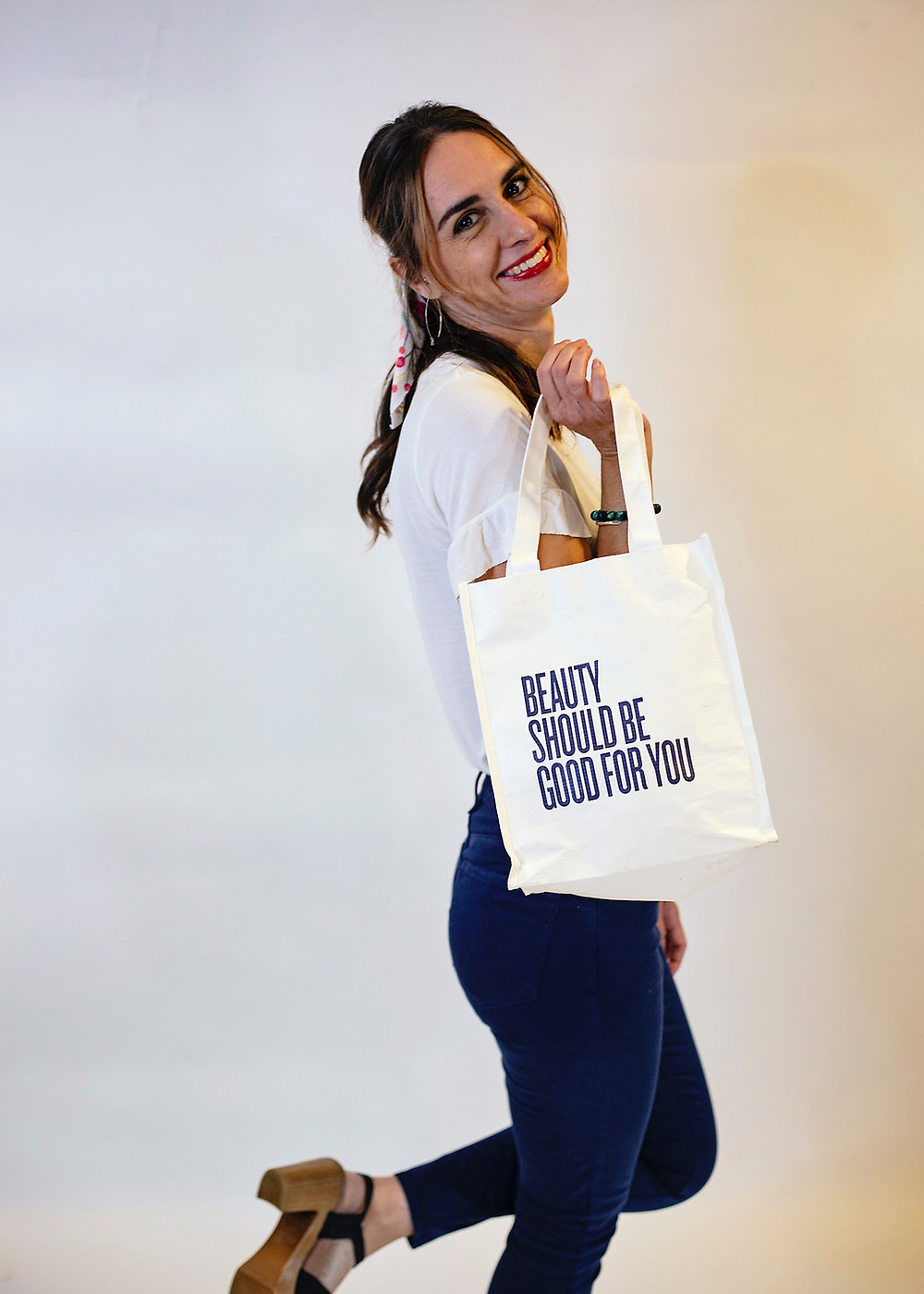 Brittany with her Beautycounter bag that reads "Beauty should be good for you"