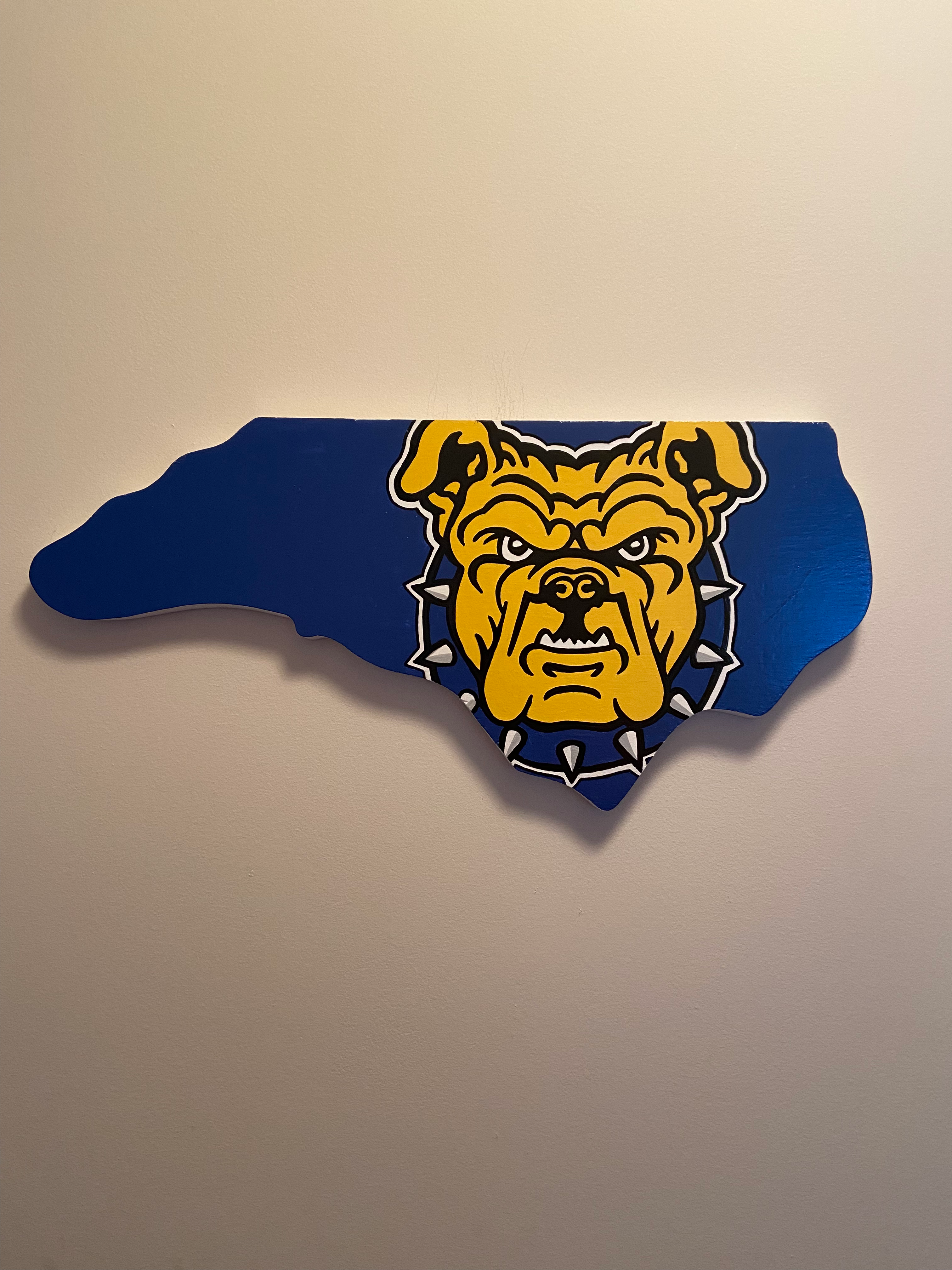 NC A&T handpainted wooden sign in the shape of NC