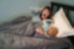 A frustrated mom putting her toddler to bed.