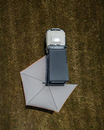 Campingfahrzeug auf Feld: Dachzelt ausgeklappt