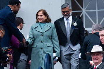 Ghazala Hashmi walks down steps with her husband Azhar Rafiq