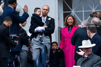 Jay Jones walks down steps with his family
