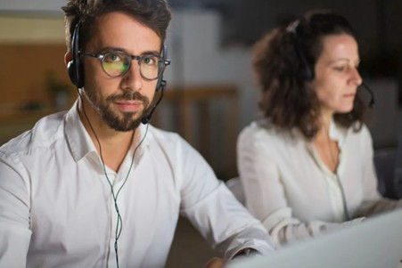 Remote it support in Dallas: two help-desk technicians with headsets providing secure, same-day computer assistance for homes and small businesses.
