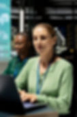 Remote cybersecurity assistance Dallas: analysts on laptops in a secure ops center delivering real-time threat defense.