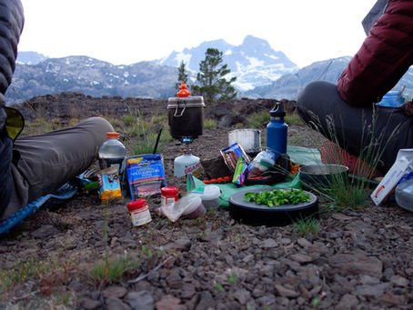Outdoor athlete eating a post-activity recovery meal to reduce muscle soreness after hiking in Vermont